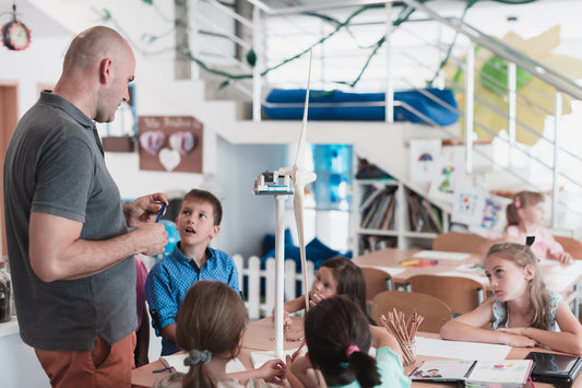 Teacher interacting with students in a classroom setting