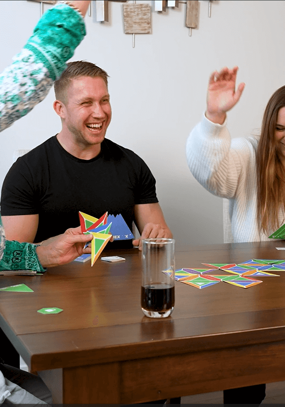 Group laughing while playing the easy-to-learn strategy game Trigahex