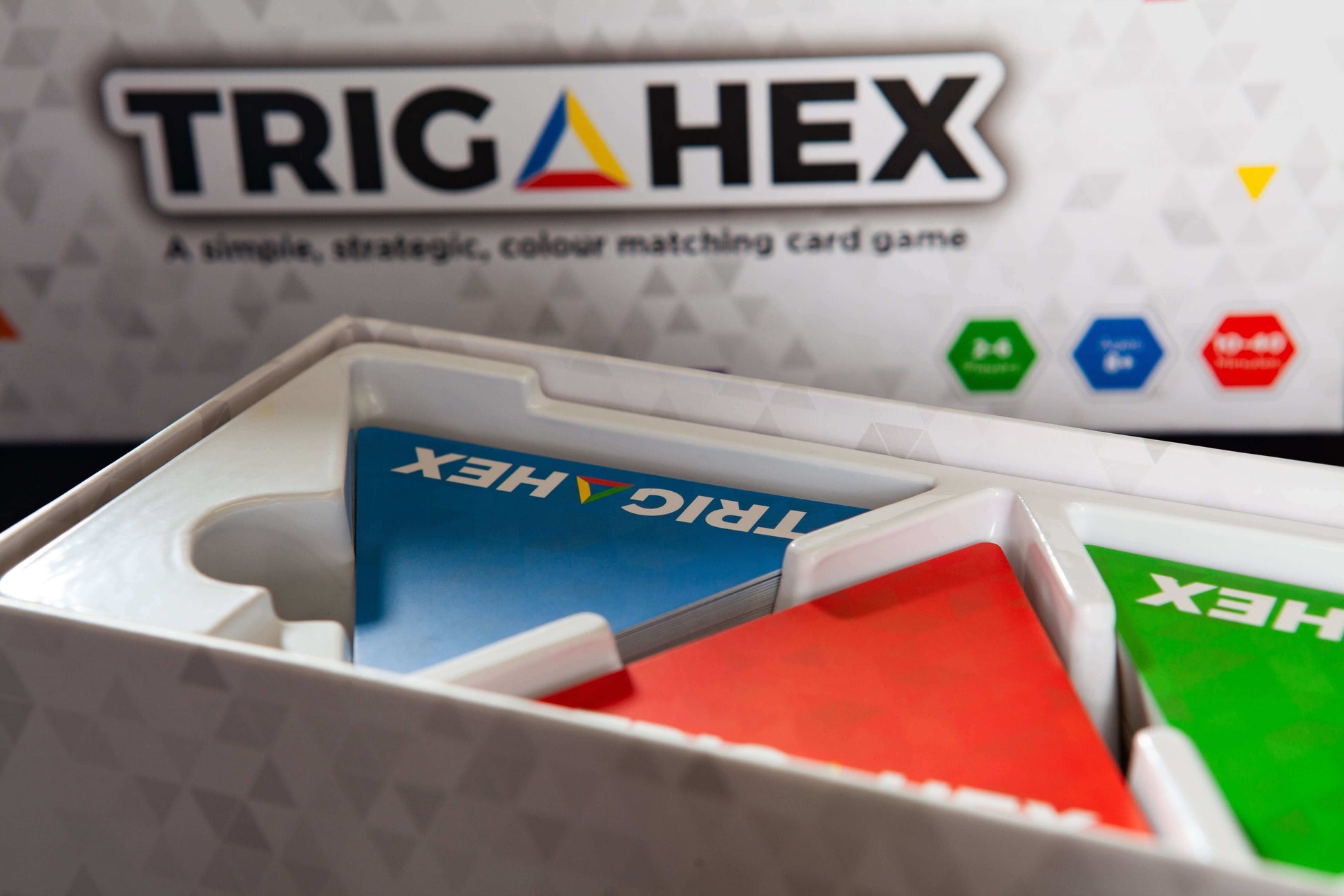 A detailed view of the Trigahex game box, showcasing its vibrant design and branding for this easy-to-learn, family-friendly strategy card game.