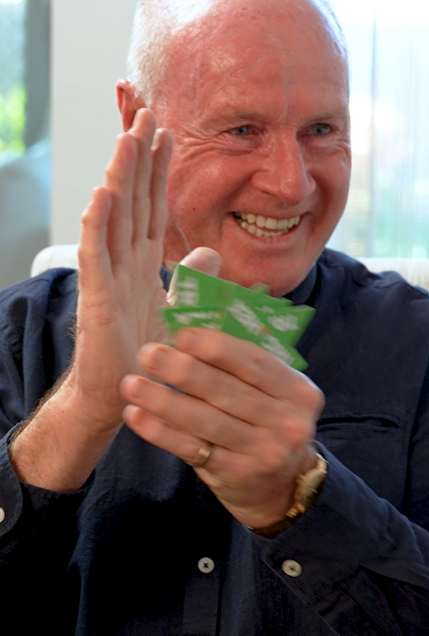 Older adults smiling while playing the easy-to-learn strategy game Trigahex