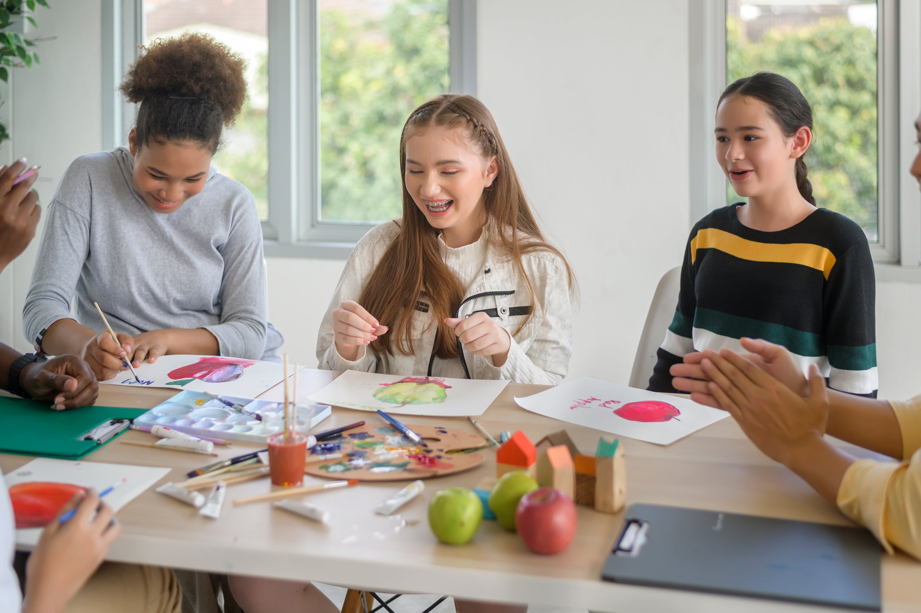 Children engaged in a project at a table with various materials.